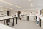 Computer Generated Image of scientists working in a bright and spacious shared lab space using specialist lab equipment