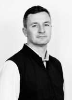 A black and white headshot of journey team member Dan Kelly