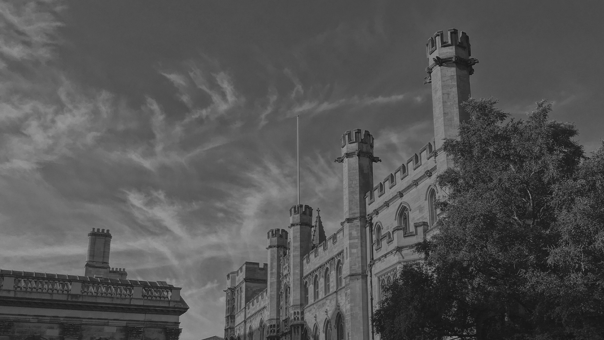 dark black and white image of a historic building in Cambridge, cropped in to focus on the detailed architecture.